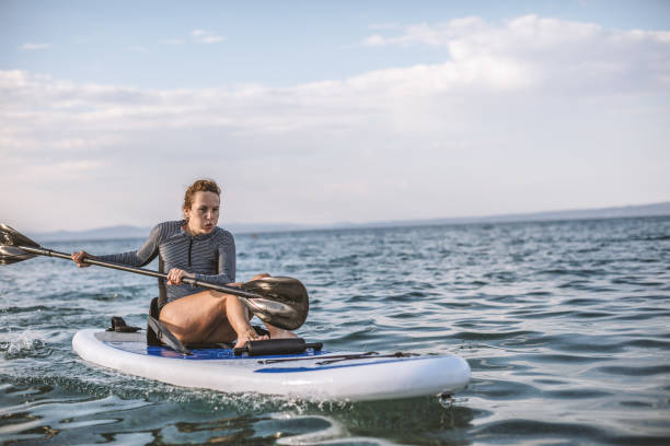 istock Woman in wetsuit with a paddle board 1089475730