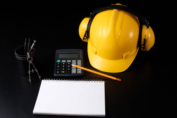 istock Engineer's desk prepared for work. Accessories prepared for a builder on a black table. Dark background. 1089476998