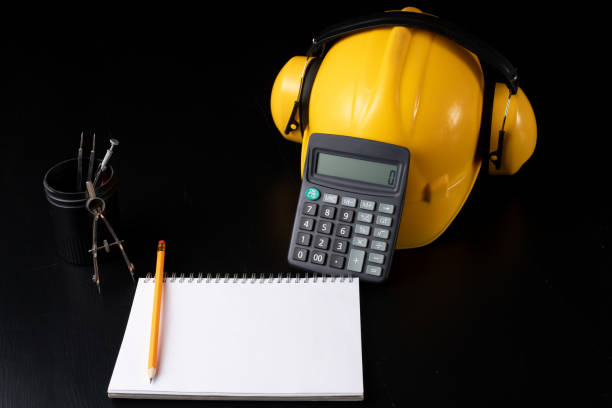 istock Engineer's desk prepared for work. Accessories prepared for a builder on a black table. Dark background. 1089477048