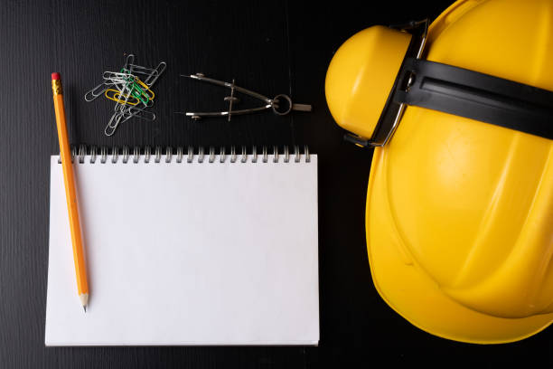 istock Engineer's desk prepared for work. Accessories prepared for a builder on a black table. Dark background. 1089477454