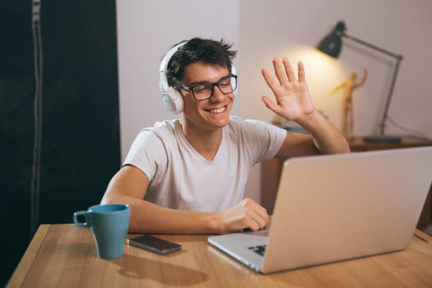 istock teenage boy using laptop at his home 1089486860