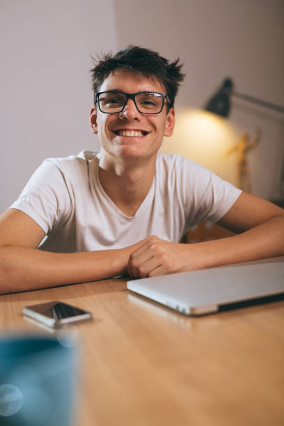 istock teenage boy using laptop at his home 1089487256