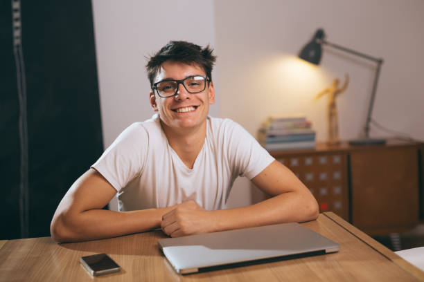 istock teenage boy using laptop at his home 1089487264