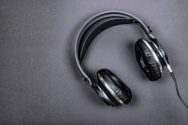istock Black professional headphones on a dark silver background. 1089496982