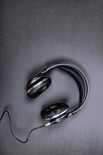istock Black professional headphones on a dark silver background. 1089497050