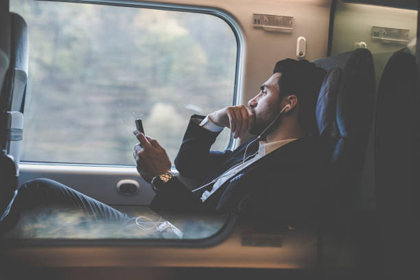 istock Bussinesman seating on a train beside window and working 1089499112