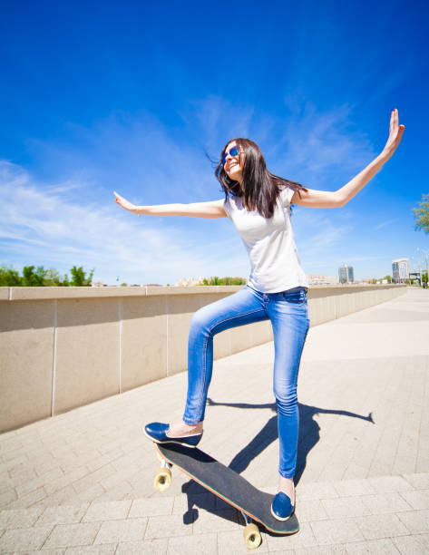 istock Woman skateboard, full height, smile 1089499840
