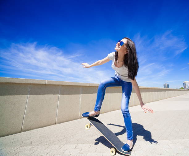 istock Woman skateboard, full height, smile 1089500136