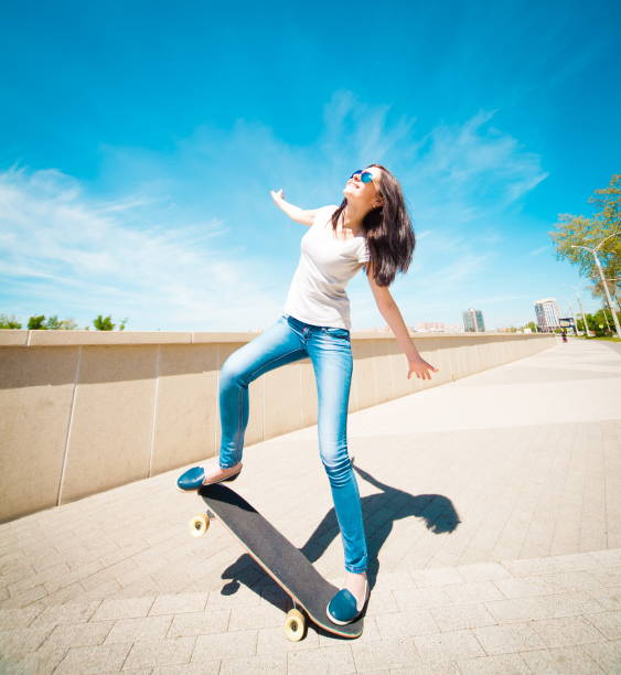 istock Woman skateboard, full height, smile 1089500400
