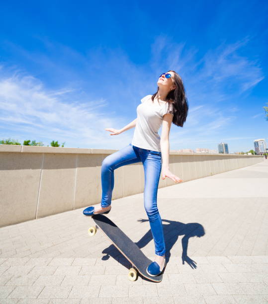 istock Woman skateboard, full height, smile 1089501634