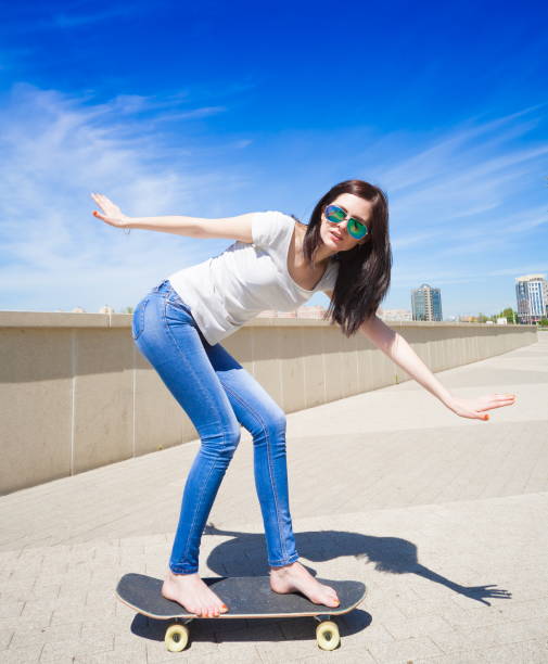 istock Woman skateboard, full height, smile 1089501696