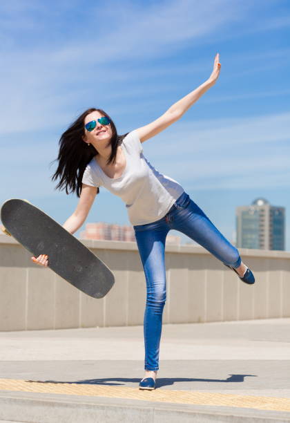 istock Woman skateboard, full height, smile 1089501908