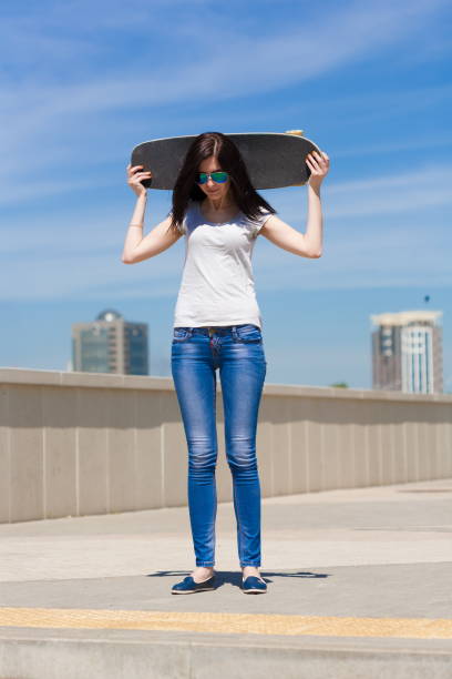 istock Woman skateboard, full height, smile 1089502036