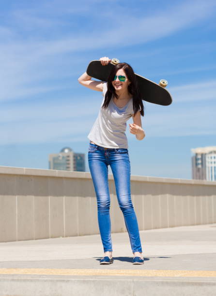 istock Woman skateboard, full height, smile 1089502082