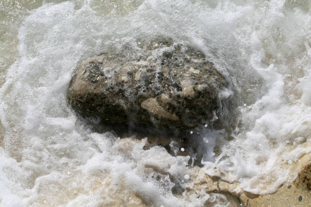 istock Sea foam around a big stone 1089506562