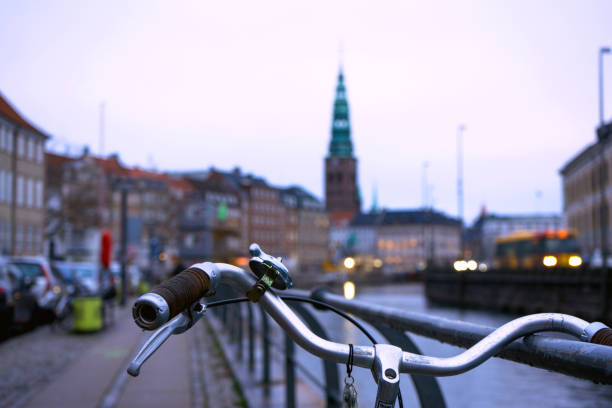 Bicycle's wheel in front of a Copenhagen cityscape