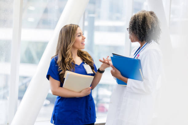 istock Young Hispanic female doctor talking with colleague 1089509094