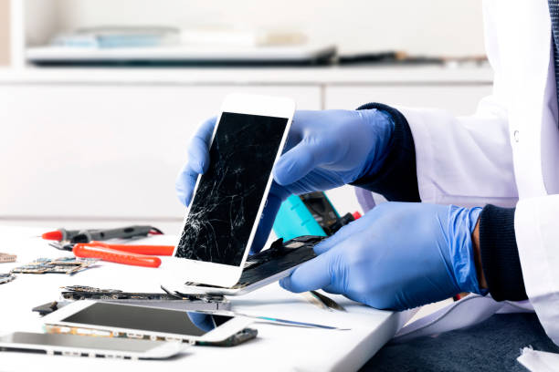 istock Serviceman is repairing a damaged mobile phone 1089509210