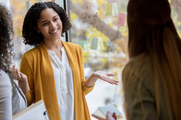 istock Creative female shrugs towards teammates 1089509308
