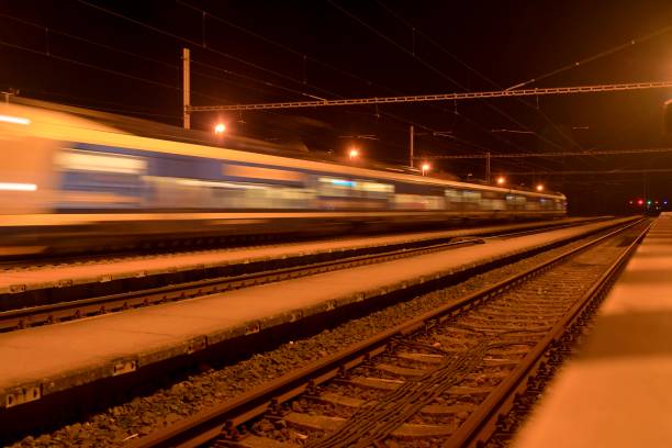 istock High speed passenger train on tracks with motion blur effect at night. Railway station in the Czech Republic 1089512218