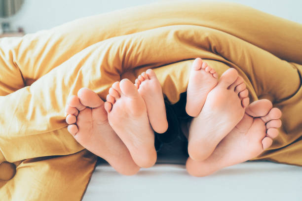 Family feet Family feet from under blanket bed human foot couple two parent family stock pictures, royalty-free photos & images