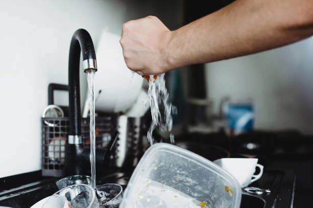 istock The man cleans dirty dishes with a dishcloth. 1089519248