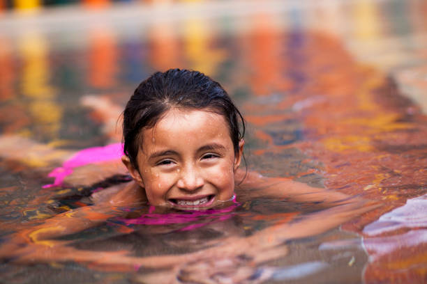istock Little Girl playing alone in the pool 1089521082