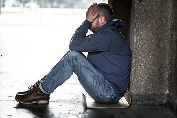istock Homeless Depressed Man Sitting in Cold Subway Tunnel 1089522680
