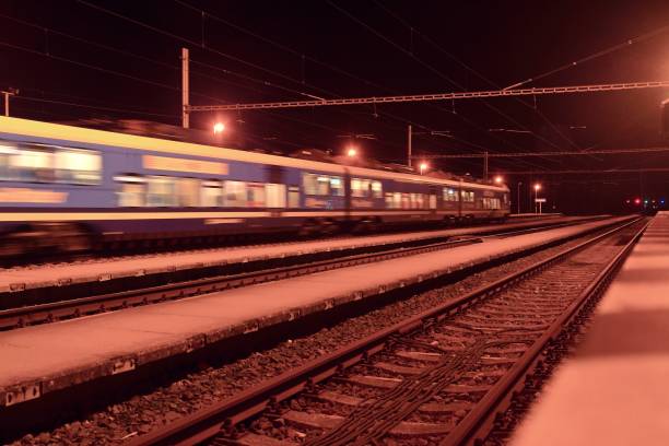 istock Passenger train on railroad tracks at night  Blurred motion 1089522860