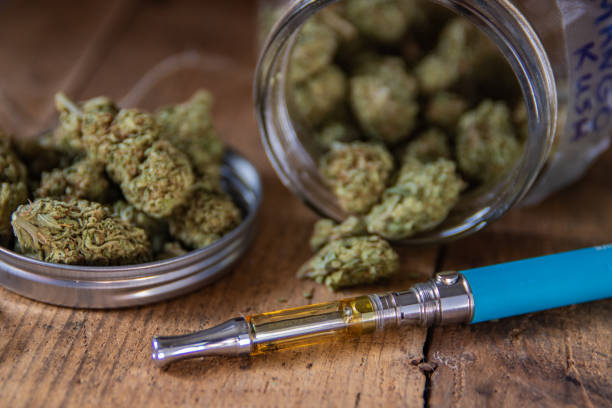 Cannabis Oil Vape Pen Marijuana Buds In Open Glass Jar Stock Photo -  Download Image Now - iStock