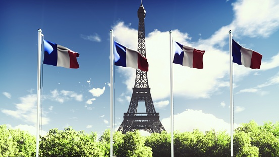 The Flag Of France. Beautiful   of the French flag on the background of blue sky, clouds and Eiffel tower.