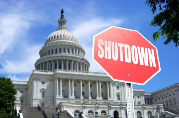 Government Shutdown concept: Stop sign in front of US Capital Building Concept stock photo