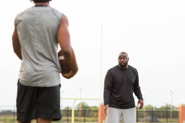 istock American Football coach training a young athlete. 1089550848
