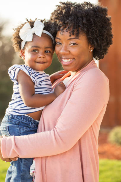 istock African American mother picking up her daughter. 1089552234