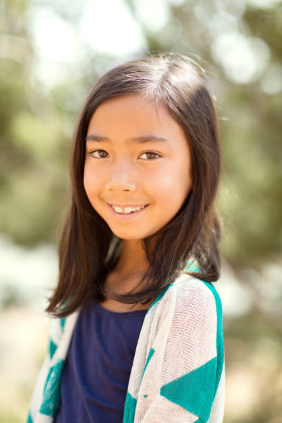 istock Young asian girl smiling outside. 1089552522