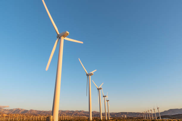 Windmill against clear blue sky on sunny day