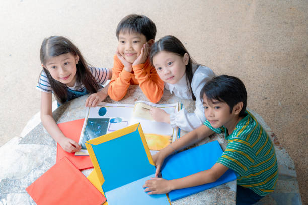 istock Asian Little Children Reading Book Cheerful 1089567588