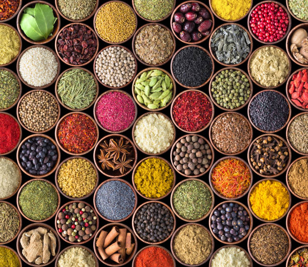 istock various condiments in cups, food background. Spice texture isolated on black 1089568950