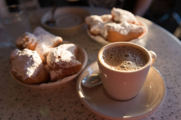 fritters Sunlit Beignets in New Orleans. beignet stock pictures, royalty-free photos & images