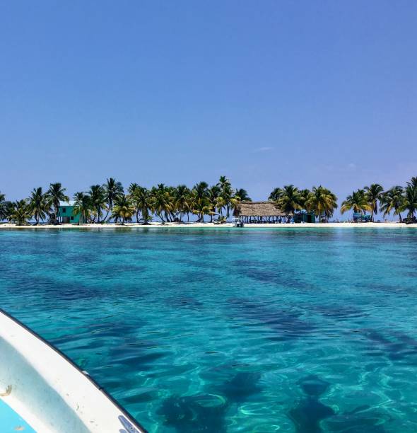 The view from a passenger travelling on a small boat to the the small tropical laughing bird caye off the coast of Belize. The view from a passenger travelling on a small boat to the the small tropical laughing bird caye off the coast of Belize.  A common spot for tourists who enjoy snorkelling and scuba diving. cay stock pictures, royalty-free photos & images