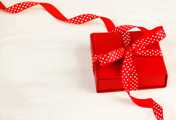 istock Gift box with red bow ribbon on white background for Valentines day. 1089592510