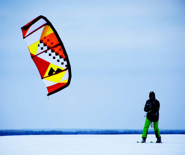 snowkite in winter cloudy day on ice of river