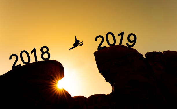 istock New year concept, silhouette a man jumping across cliff from 2018 to 2019 1089593320
