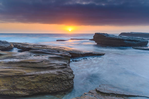 istock An Atmospheric Sunrise Seascape with Large Rocks 1089594600