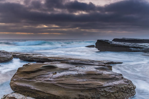 istock An Atmospheric Sunrise Seascape with Large Rocks 1089594610