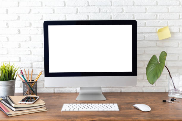 istock workspace with computer with blank white screen, and office supplies on a wooden desk 1089601548