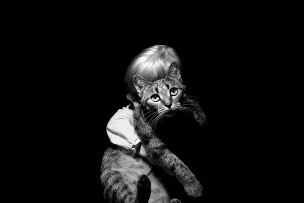 istock Baby hugging his cat on black and white 1089611350