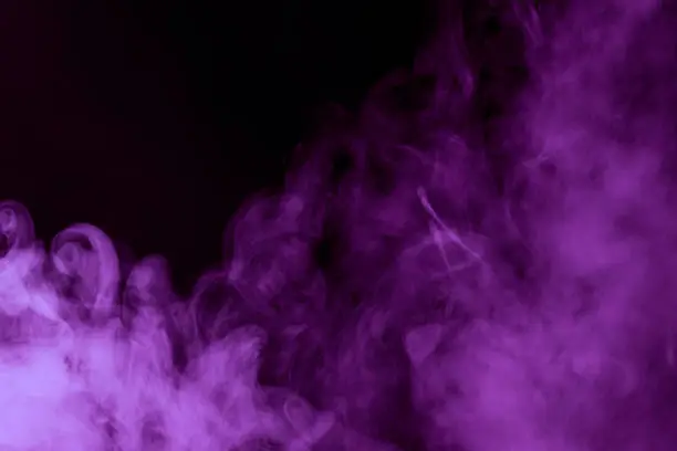 Photo of mystical purple steam on a dark background Cloud Close up