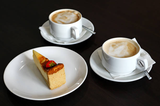 istock Two cappuccinos and a piece cheesecake 1089633970