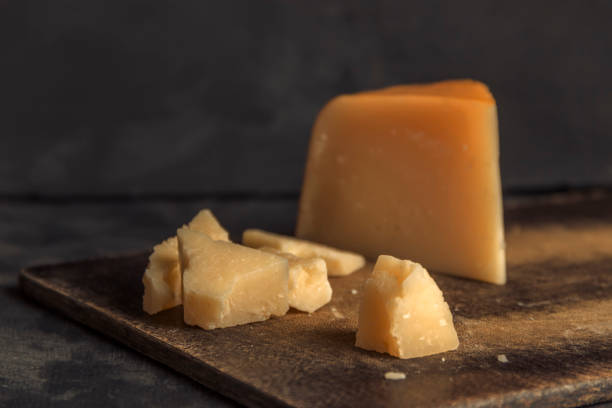 istock Parmesan cheese, sliced and pounded on a dark background 1089638068